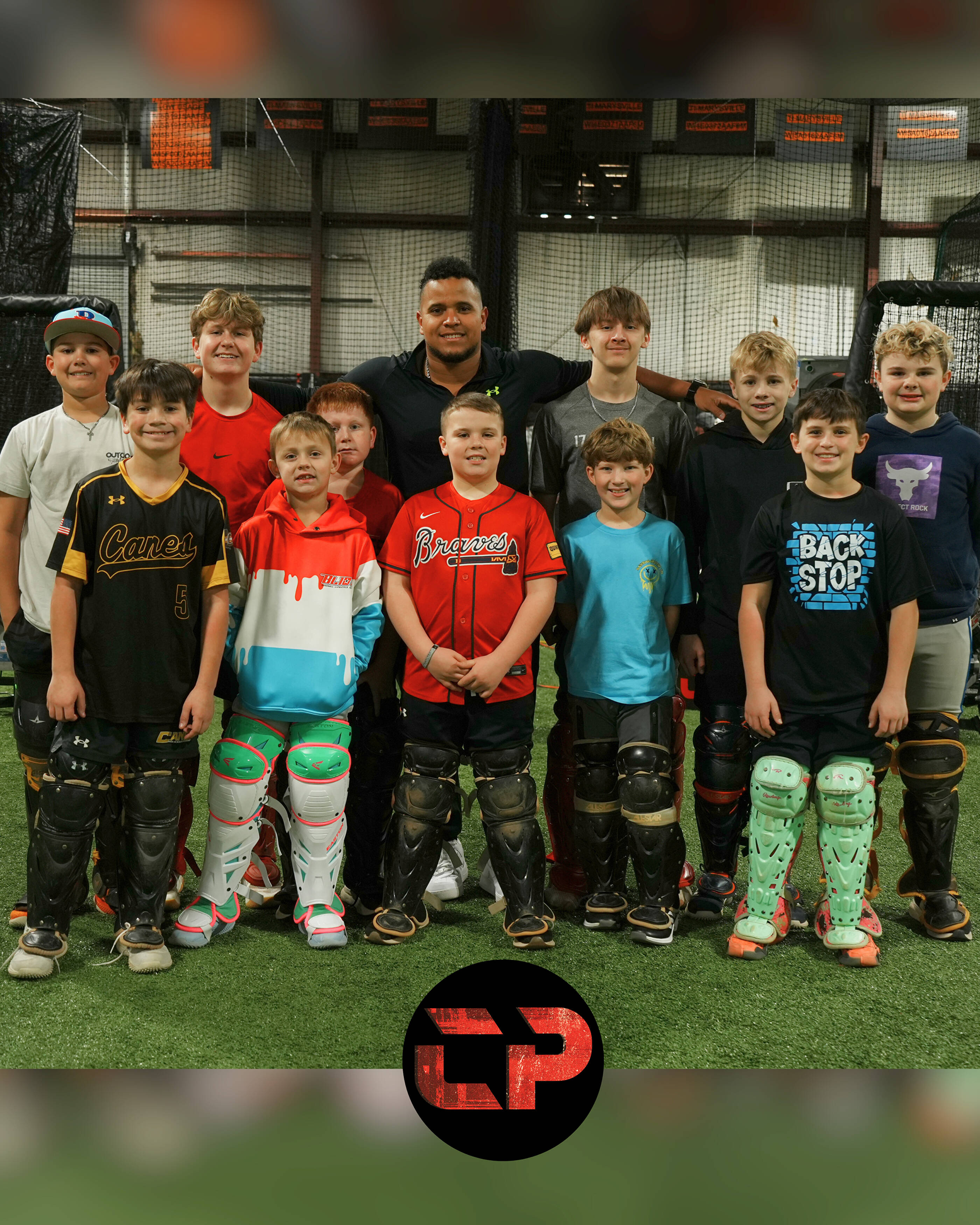 Coach Andrés with a group of catchers inside the CATCHPRO ACADEMY facility