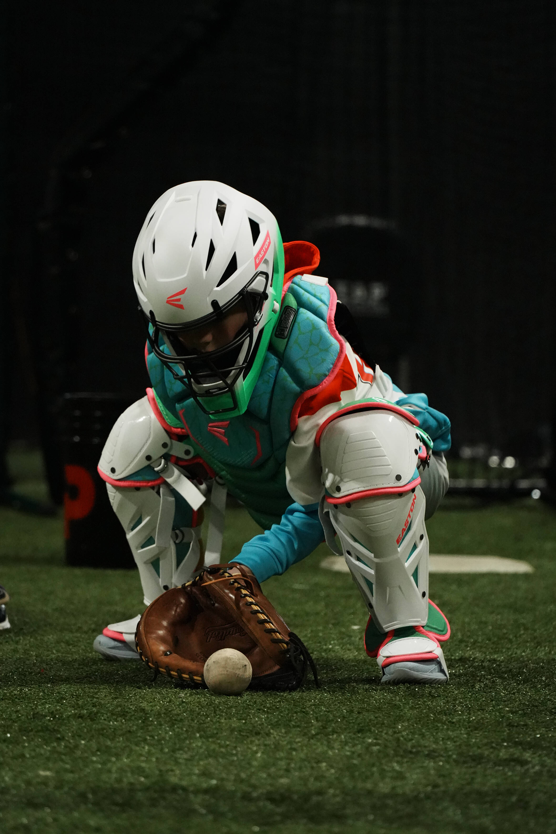 Young catcher practicing a low blocking position